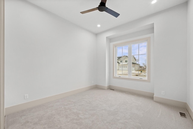 unfurnished room featuring light carpet and ceiling fan