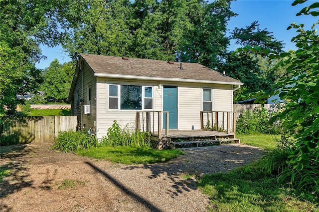 bungalow featuring cooling unit and a deck