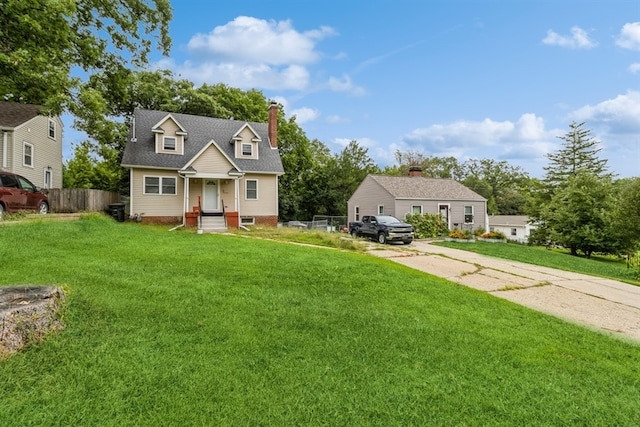 cape cod-style house featuring a front yard