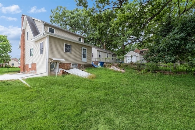 rear view of house with a yard