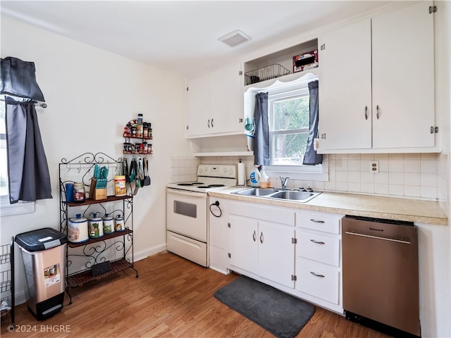 kitchen featuring white electric range oven, light countertops, visible vents, a sink, and dishwasher