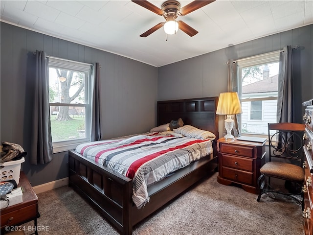 bedroom with multiple windows, carpet flooring, and a ceiling fan