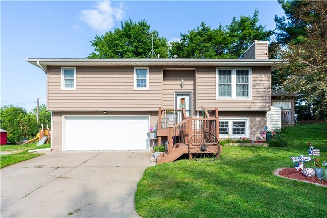 raised ranch with a garage and a front lawn