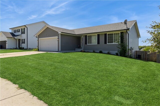 view of front facade with a garage and a front lawn