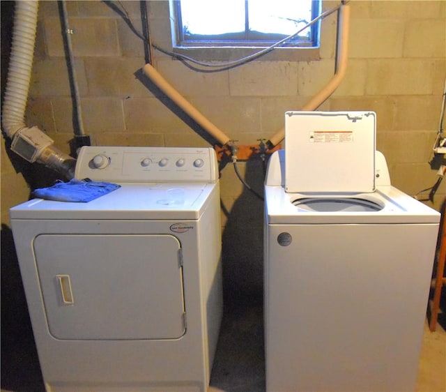 clothes washing area with washing machine and clothes dryer