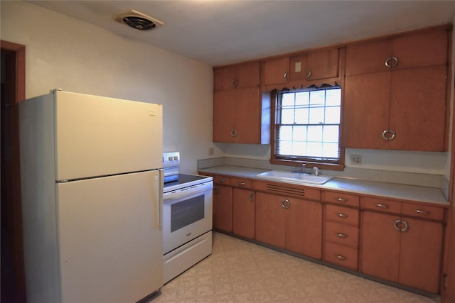 kitchen with sink and white appliances