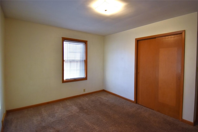 unfurnished bedroom featuring carpet and a closet