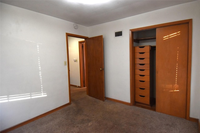 unfurnished bedroom with a closet and carpet