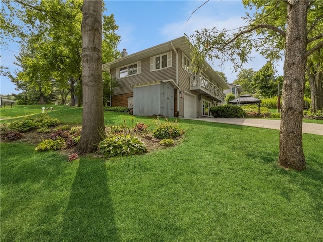 view of side of home with a lawn and a garage