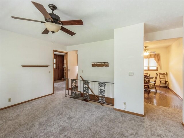 empty room featuring carpet flooring and ceiling fan