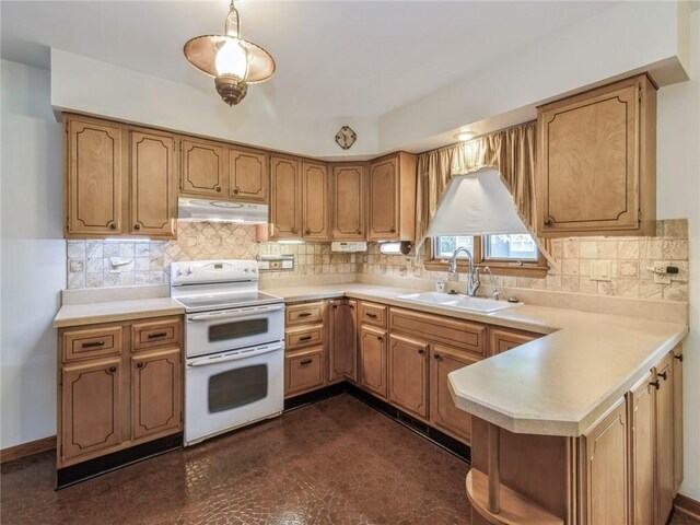 kitchen with decorative backsplash, kitchen peninsula, sink, and range with two ovens