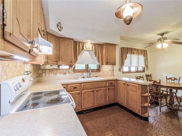 kitchen featuring white stove, backsplash, ceiling fan, sink, and wall chimney exhaust hood