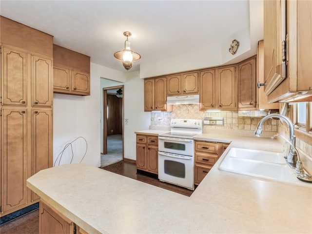 kitchen with double oven range, sink, decorative backsplash, kitchen peninsula, and decorative light fixtures