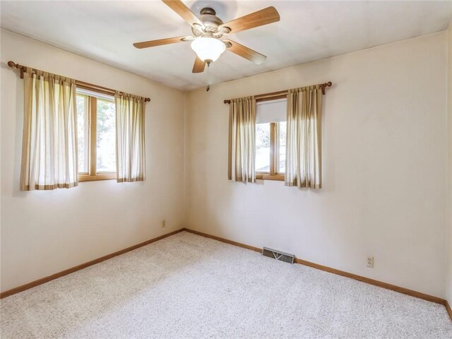 unfurnished room with ceiling fan and carpet flooring