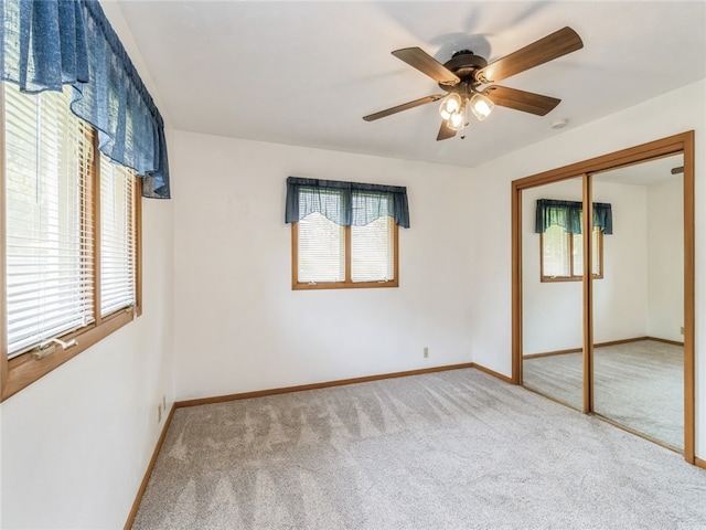 unfurnished bedroom featuring carpet, a closet, and multiple windows