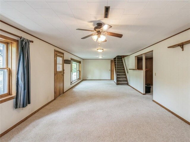 interior space with ceiling fan and light colored carpet