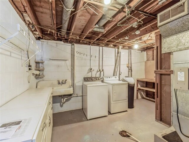 basement with sink and washing machine and clothes dryer