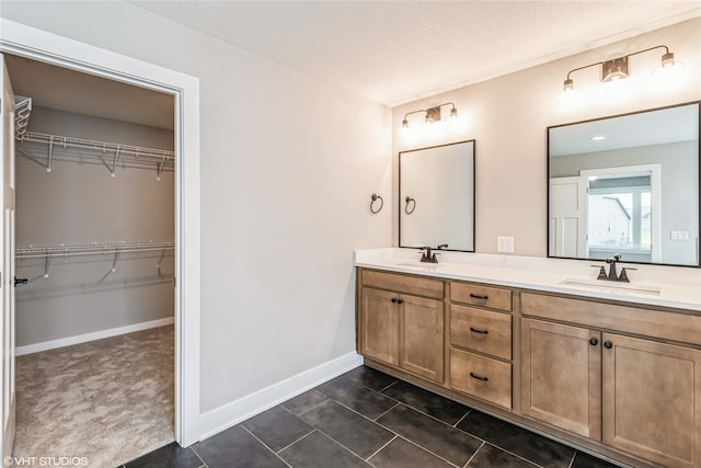 bathroom featuring vanity, tile patterned flooring, and a textured ceiling