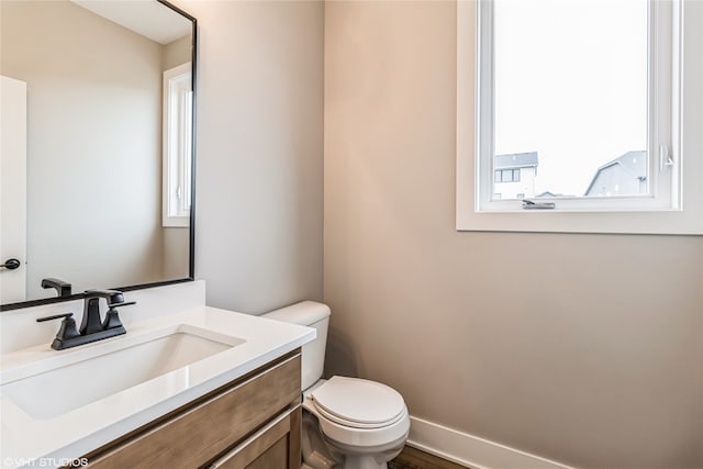 bathroom featuring toilet and vanity