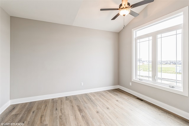 spare room featuring ceiling fan, vaulted ceiling, and light hardwood / wood-style floors