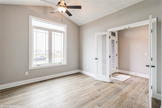 unfurnished bedroom with ceiling fan, light hardwood / wood-style floors, lofted ceiling, and french doors