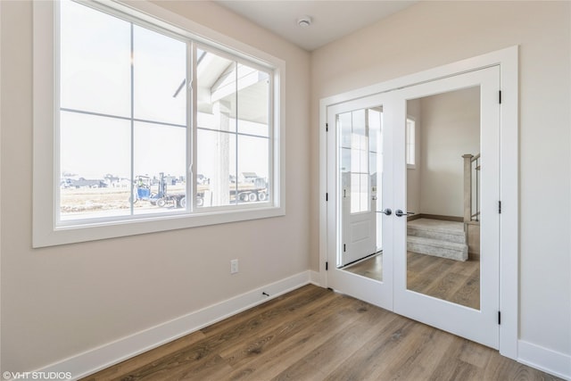 doorway with hardwood / wood-style floors and french doors