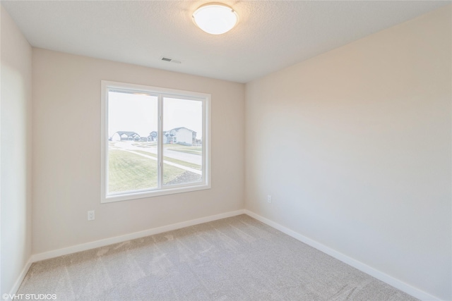 empty room with light colored carpet