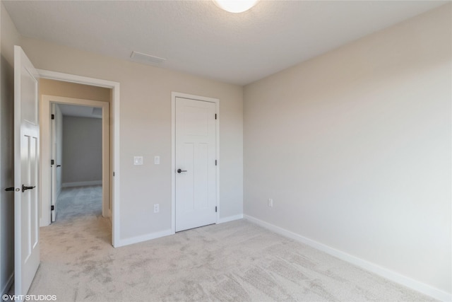 unfurnished bedroom with light carpet