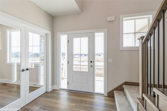 entrance foyer with dark hardwood / wood-style floors and french doors