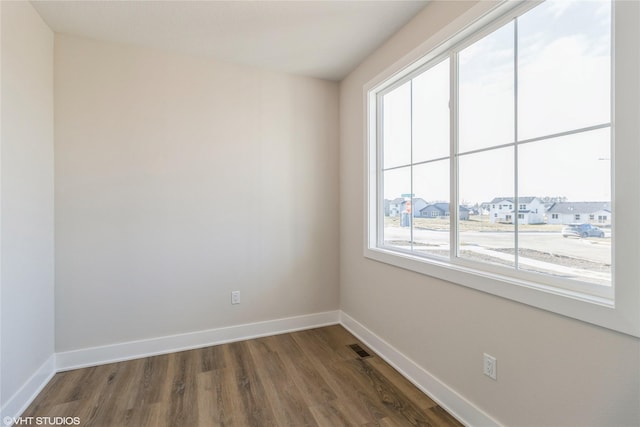 spare room featuring dark wood-type flooring