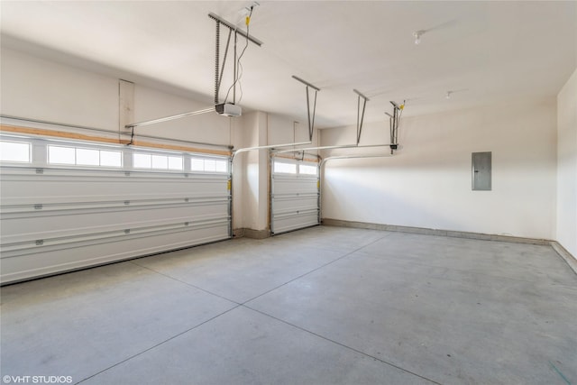 garage with a garage door opener and electric panel