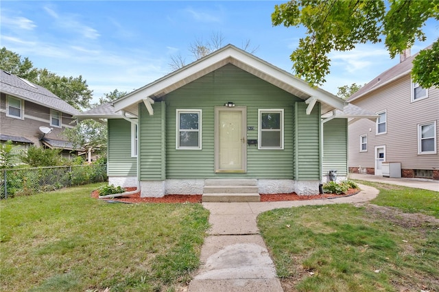 bungalow-style home with a front yard