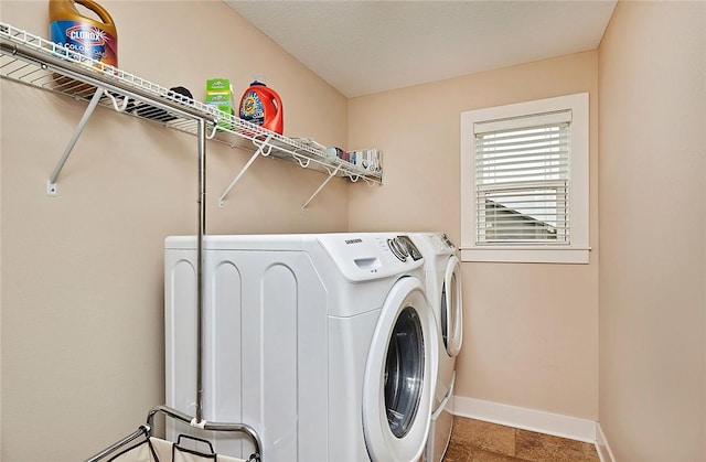 clothes washing area with washing machine and dryer