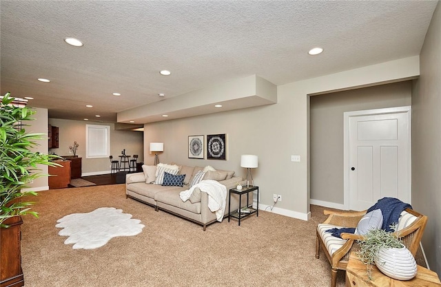 living room featuring carpet floors and a textured ceiling