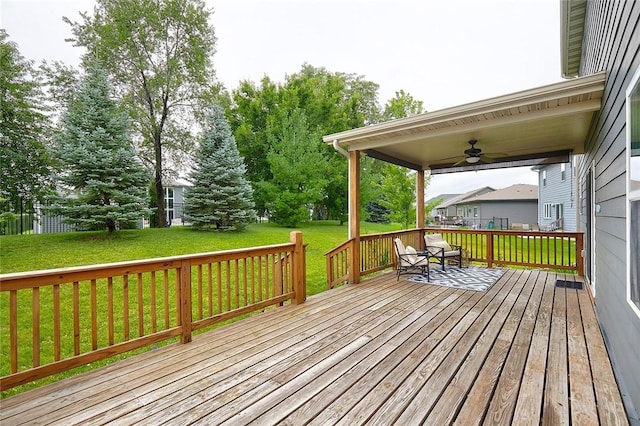 deck with ceiling fan and a yard