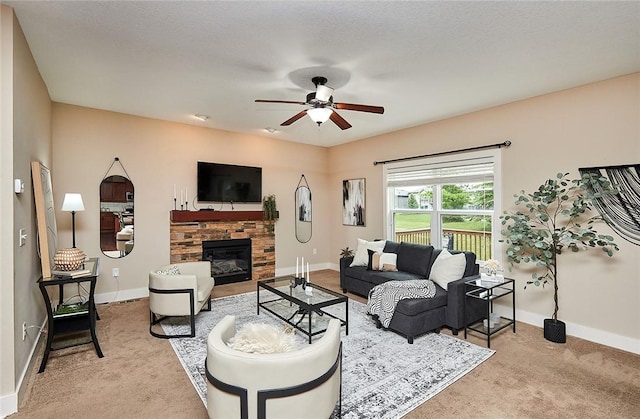 living room with ceiling fan, light carpet, and a fireplace