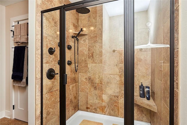 bathroom featuring a shower with shower door