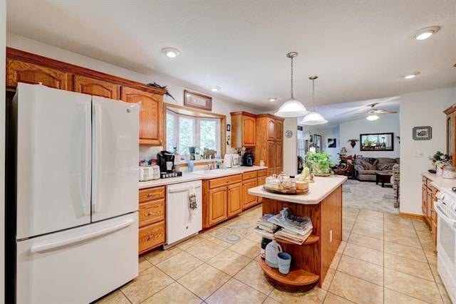 kitchen with white appliances, hanging light fixtures, light tile patterned floors, ceiling fan, and a center island