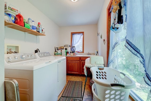 clothes washing area featuring cabinets, separate washer and dryer, and tile patterned flooring