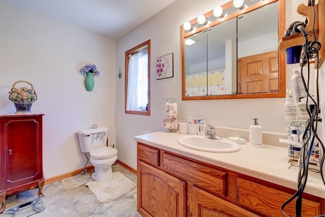 bathroom with vanity, toilet, and tile patterned flooring