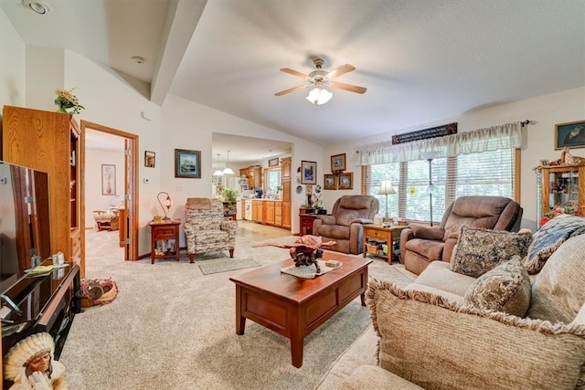 living room with ceiling fan, light carpet, and vaulted ceiling