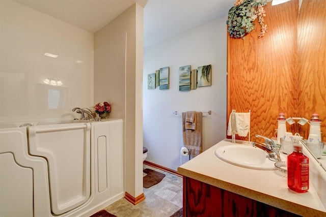 bathroom with vanity, toilet, and tile patterned flooring