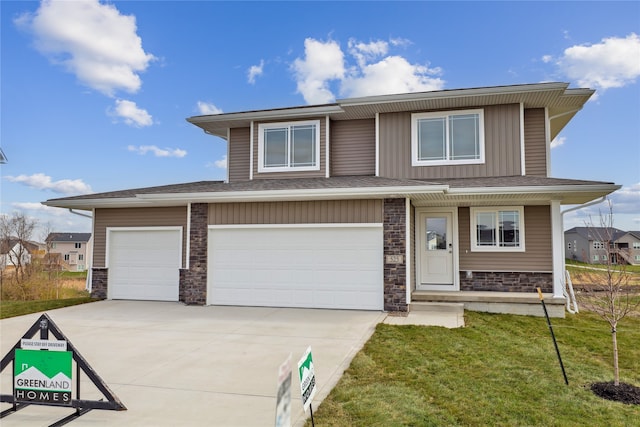 view of front of home featuring a garage and a front lawn