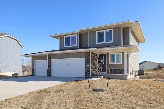 view of front of house with a garage and central AC