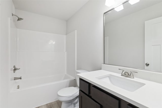 full bathroom featuring vanity, wood-type flooring, tub / shower combination, and toilet