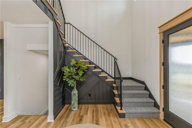 stairway with hardwood / wood-style floors