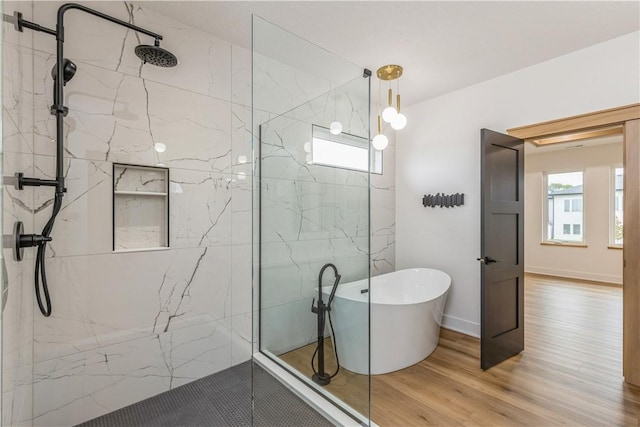 bathroom featuring hardwood / wood-style floors and shower with separate bathtub