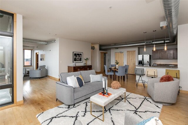 living room with sink and light hardwood / wood-style floors