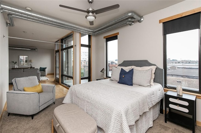 bedroom with ceiling fan and access to exterior