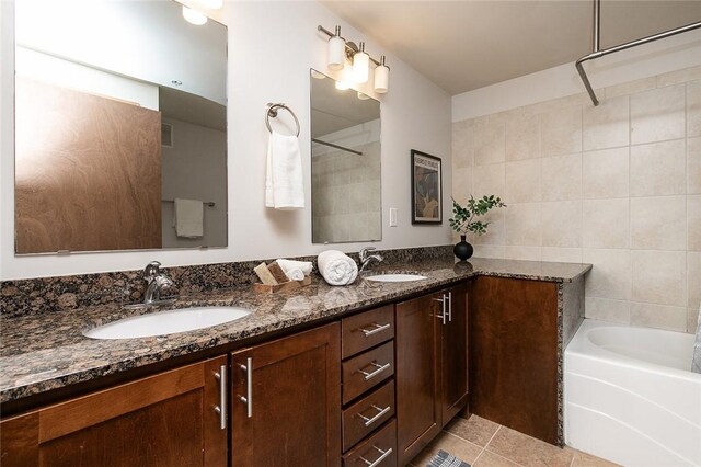 bathroom with dual vanity and tile patterned flooring